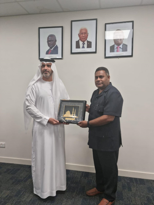 The Supervising Minister of Foreign Affairs and External Trade, Hon. Rexon Ramofafia receives a gift from the non-resident United Arab Emirates Ambassador to the Solomon Islands, His Excellency Abdullah Al Subousi.